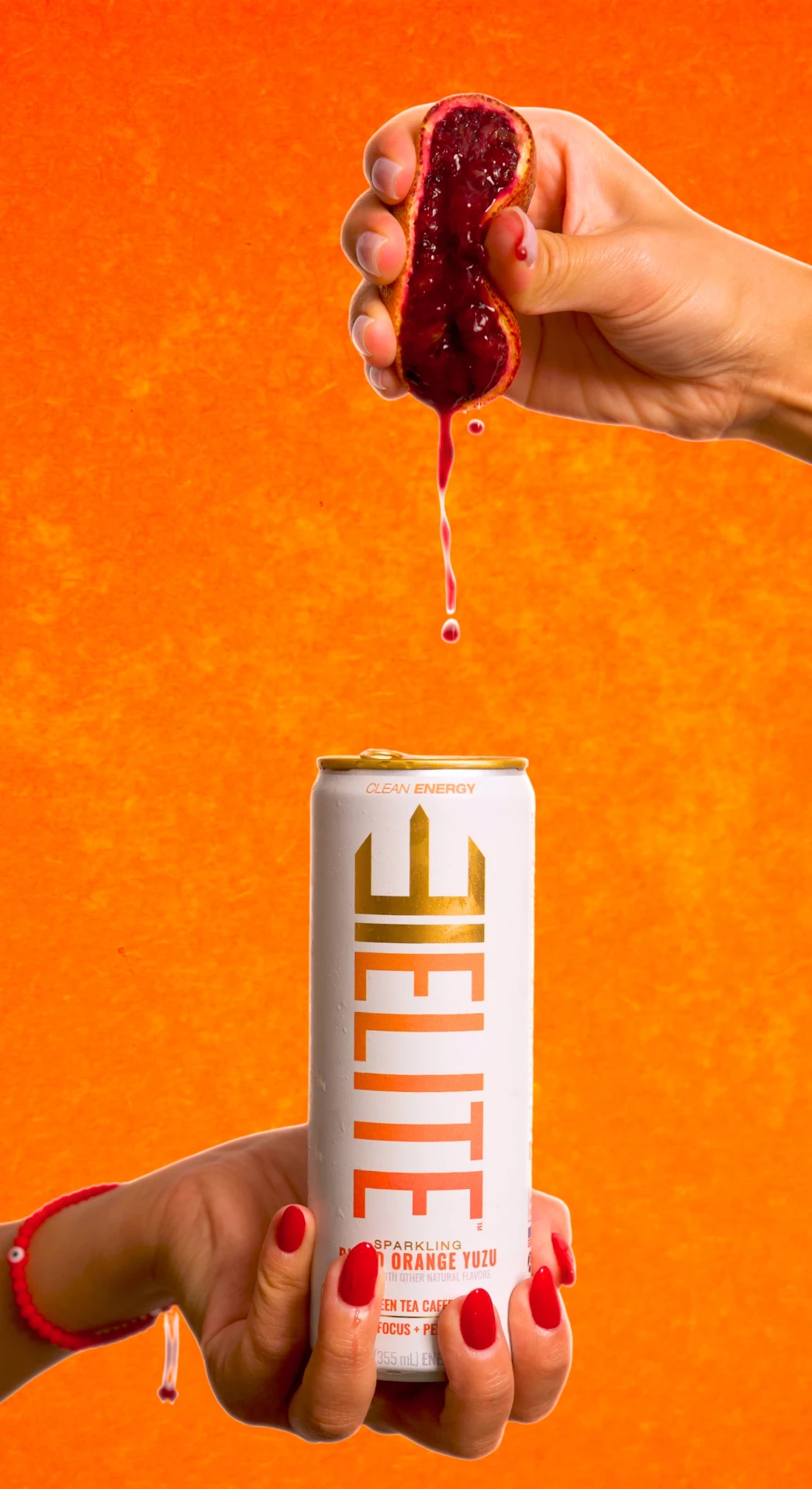 Blood orange squeezed above an ELITE can